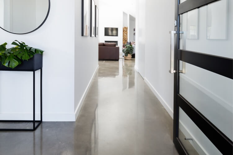 White-walled hallway featuring a black door.