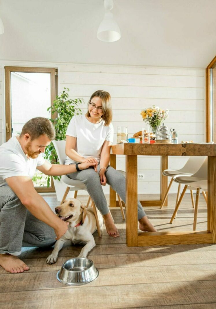 Young couple with dog at home | Rock Tops Surfaces